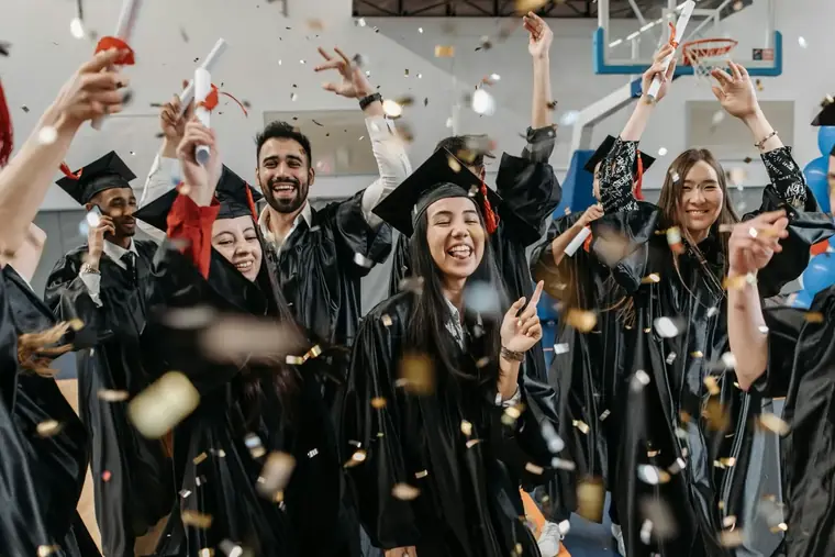 Graduates celebrating academic success with confetti
